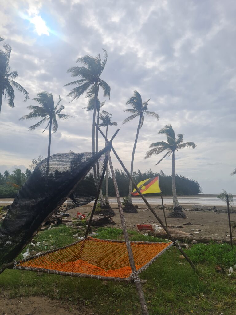 Relaxing hammock net setup under coconut trees at Redbee Camp, perfect for solo travelers.