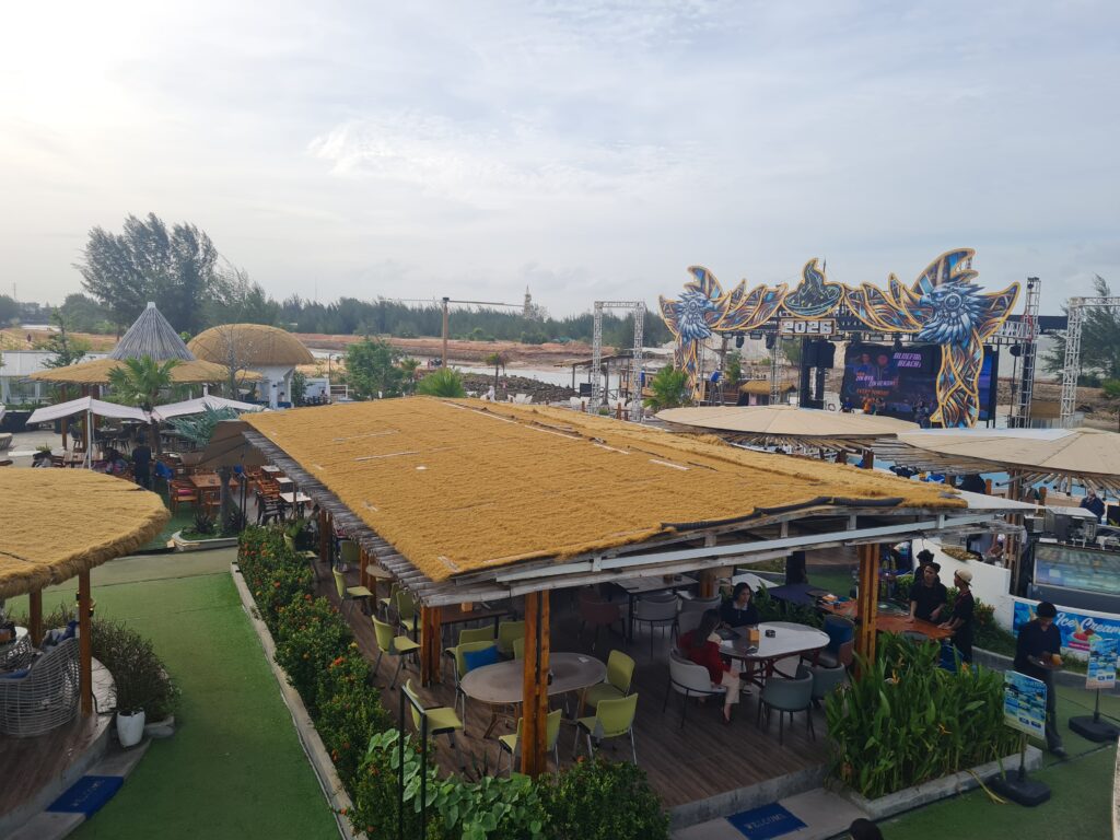 Thatched roof architecture and open-air layout of Bluefire Beach Club.