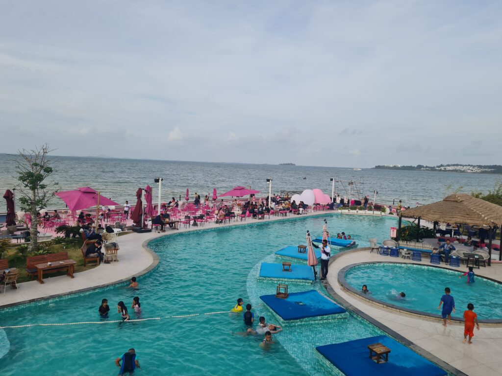 Panoramic view of the crowd and pool area from the upper deck of Bluefire Beach Club.