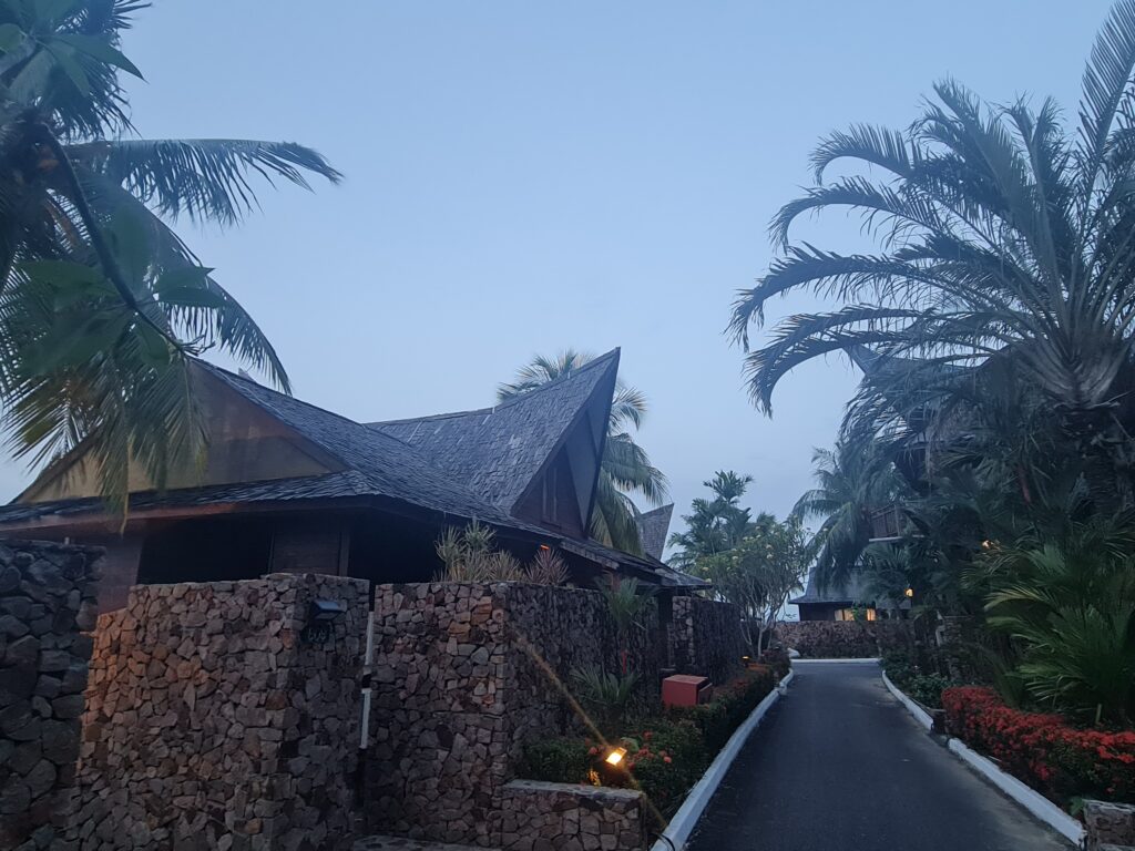 Illuminated stone walkway leading to private villas at Batam View Beach Resort at night.