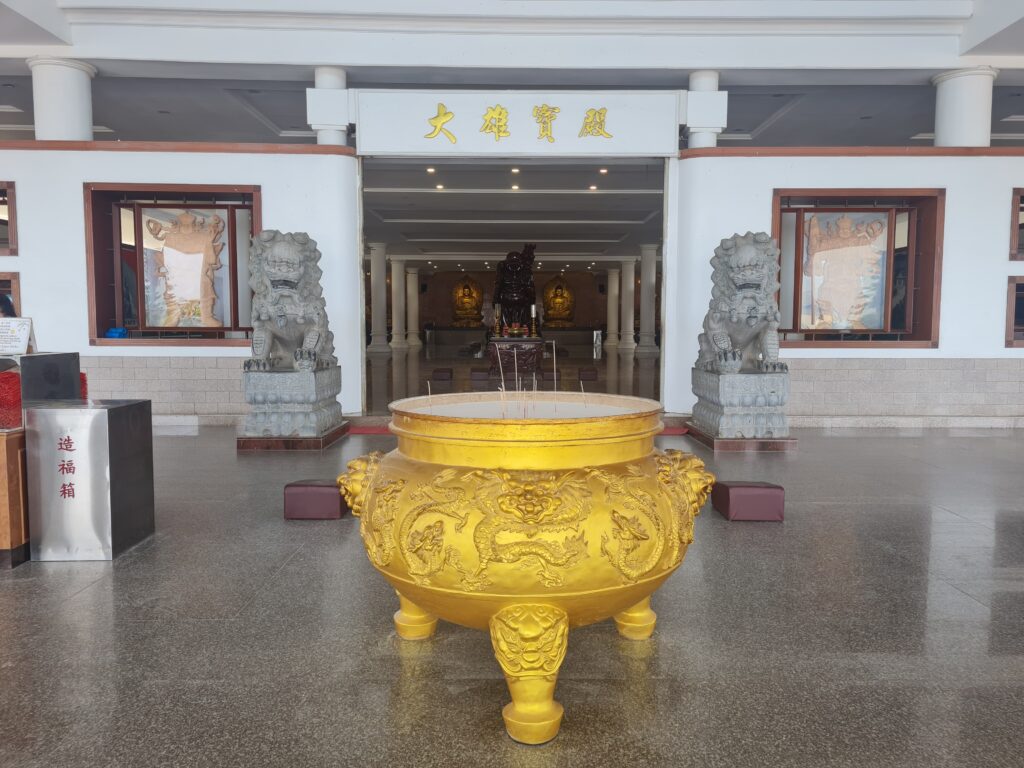Large golden incense burner in front of the Daxiong Baodian hall at the Batam monastery.