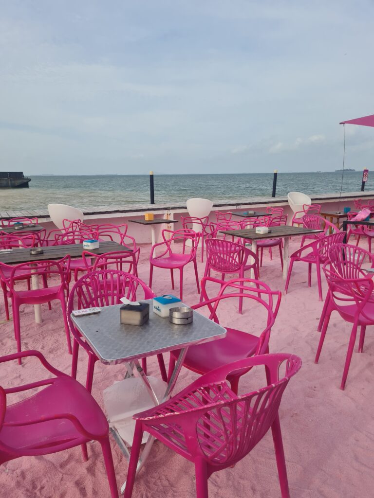 View of the Singapore Strait and barges from the Bluefire Beach Club seating area.